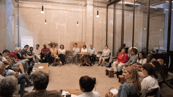 Members of the Tällberg Foundation sit in a circle and discuss